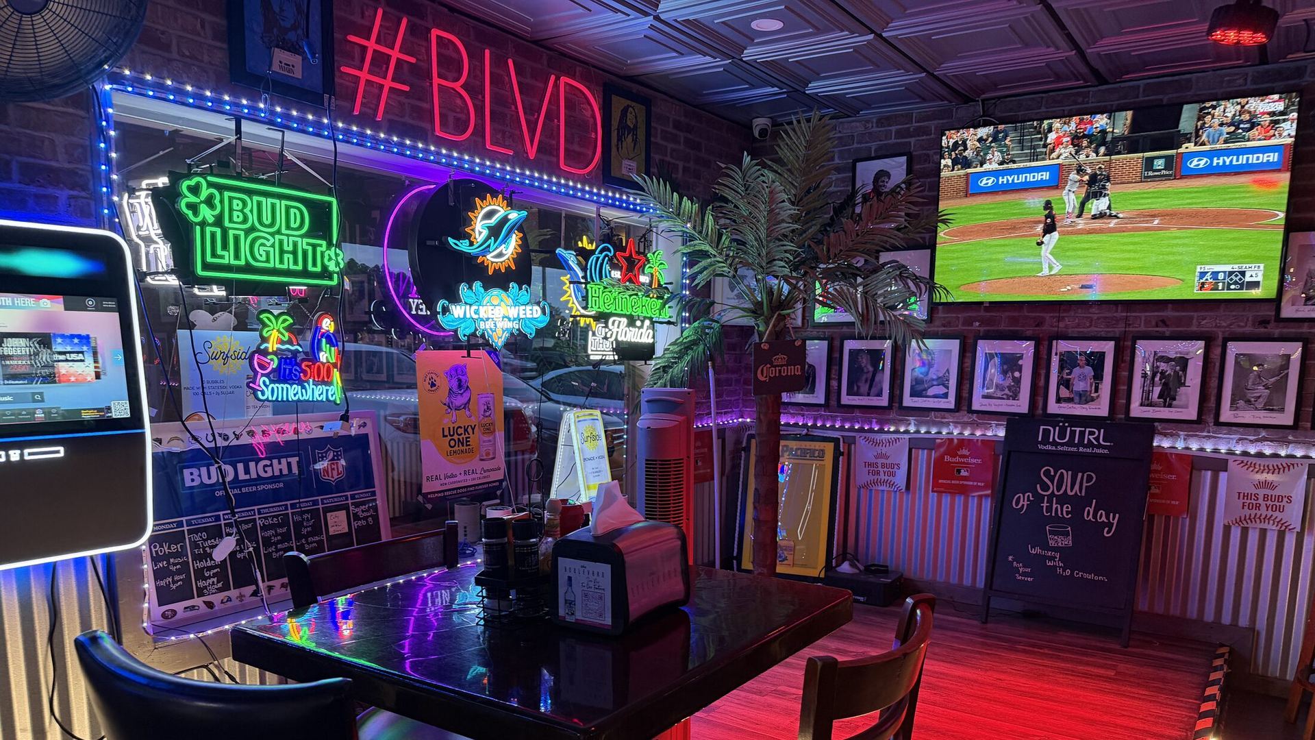 The #BLVD neon wall, LED rope lights and big-screen TVs inside The Boulevard Bar & Grill in Boynton Beach