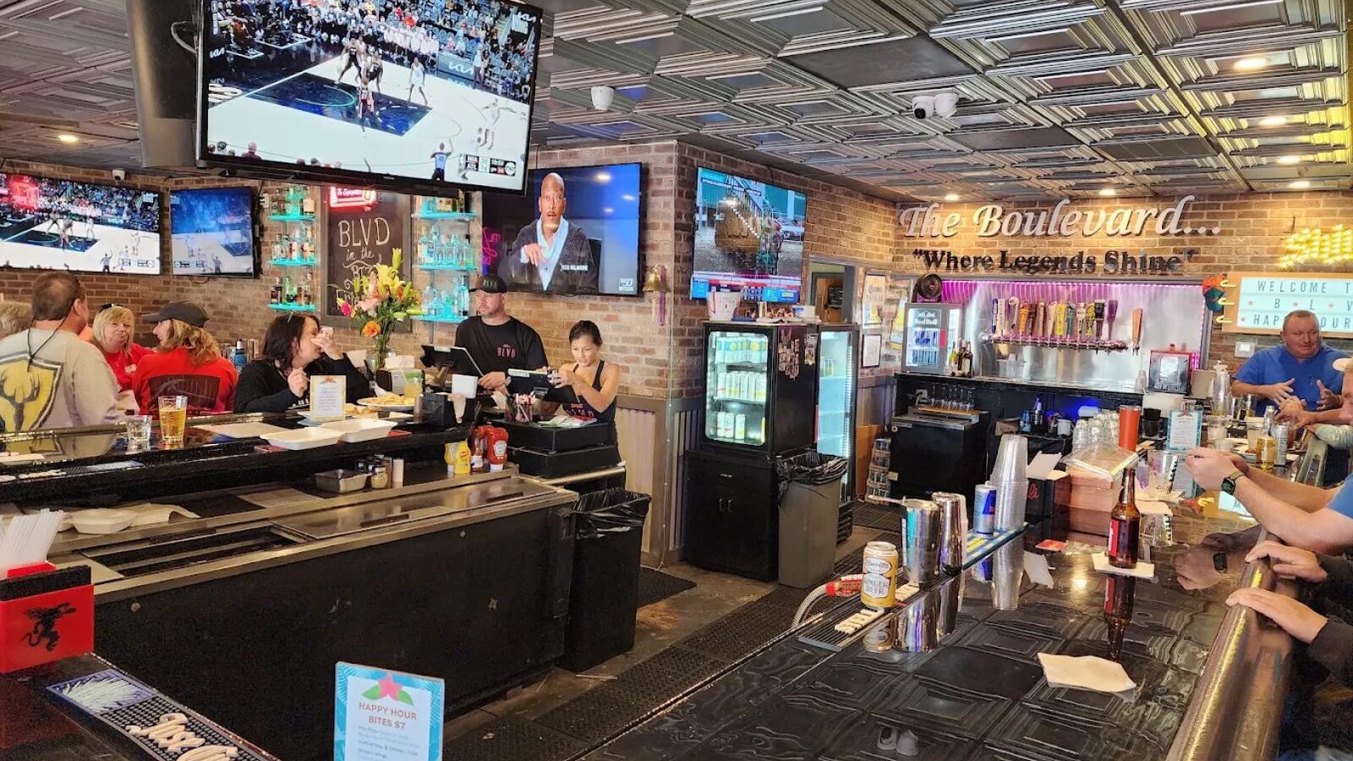 The main bar at The Boulevard Bar & Grill with draft beer taps and TVs